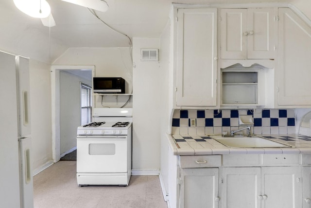 kitchen featuring tasteful backsplash, white appliances, sink, tile countertops, and white cabinets