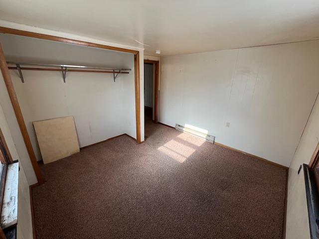 unfurnished bedroom with carpet flooring and a closet