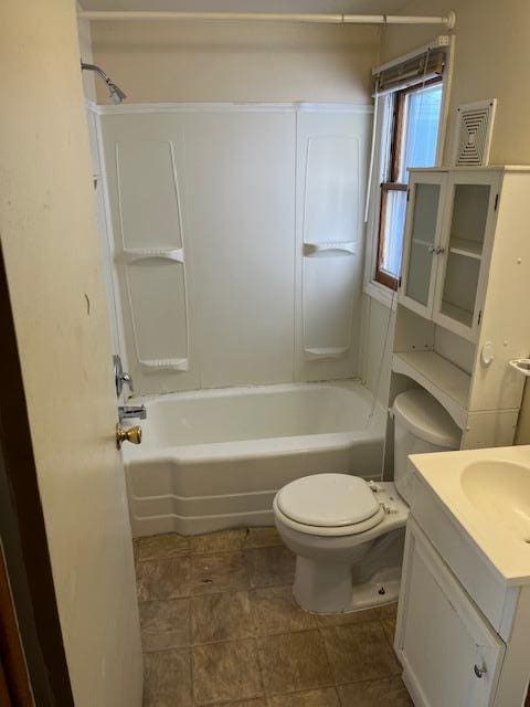 full bathroom featuring vanity, shower / bath combination, and toilet