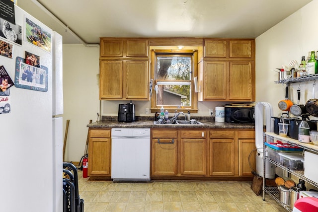 kitchen featuring sink and white appliances