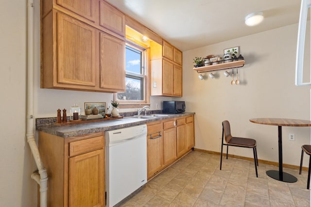 kitchen featuring open shelves, dark countertops, white dishwasher, a sink, and baseboards