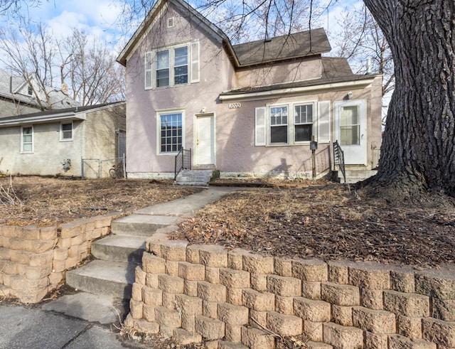 view of front of property with entry steps and stucco siding