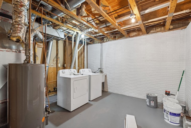 basement featuring gas water heater and washer and dryer