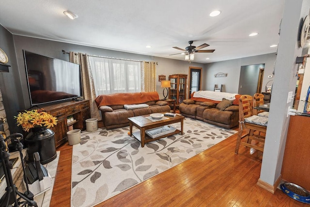 living room with recessed lighting, a ceiling fan, and light wood-style floors