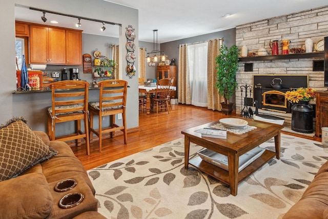 living area with light wood finished floors and an inviting chandelier