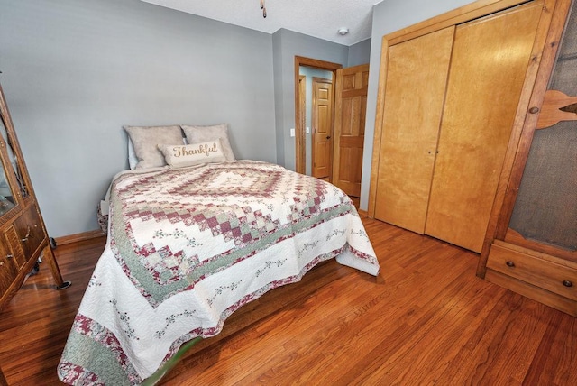 bedroom with a closet and wood finished floors