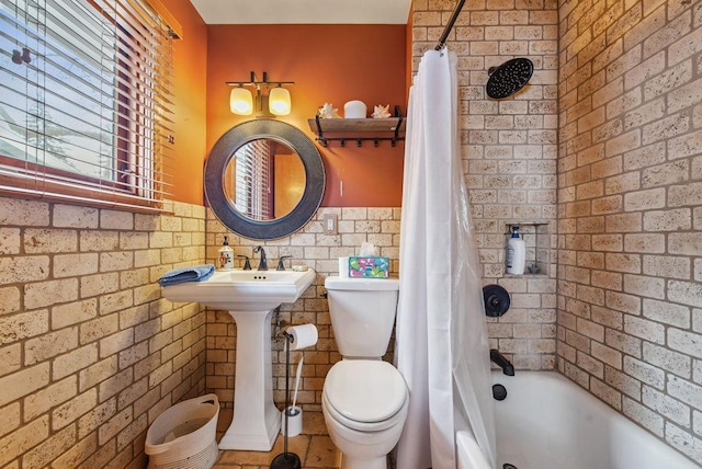 full bathroom featuring shower / bath combo, a sink, and toilet