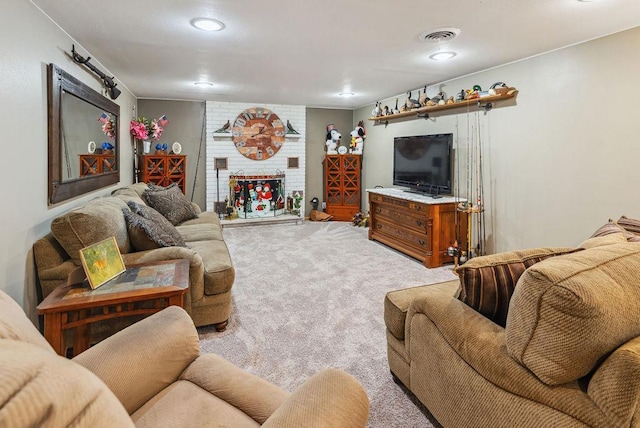 living room featuring a brick fireplace, visible vents, and light colored carpet