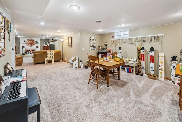 dining area featuring carpet flooring, a fireplace, visible vents, and baseboards