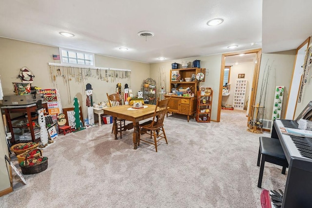 dining area featuring carpet floors and visible vents