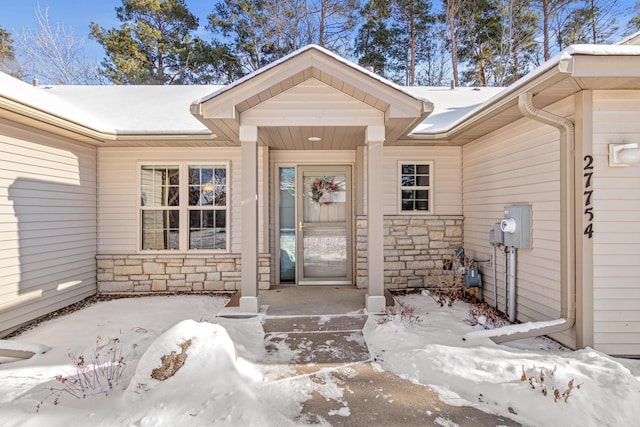 view of snow covered property entrance