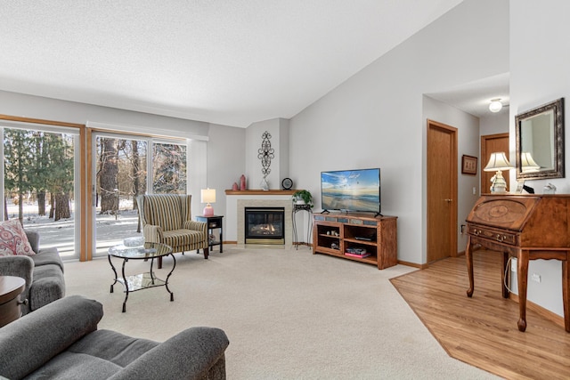 living room with vaulted ceiling and light colored carpet