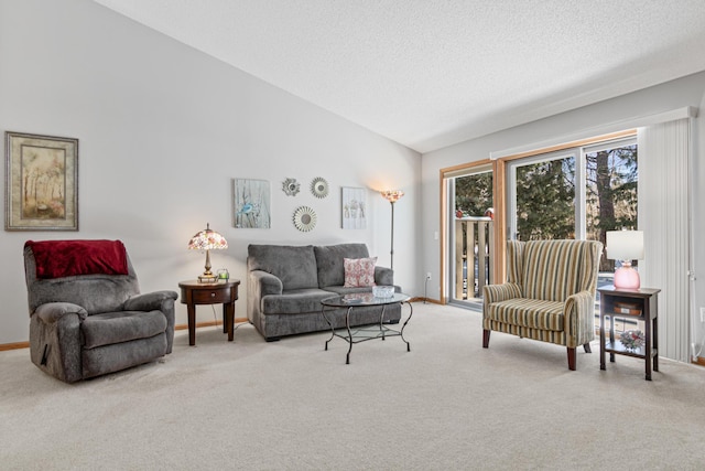 carpeted living room featuring a textured ceiling and lofted ceiling