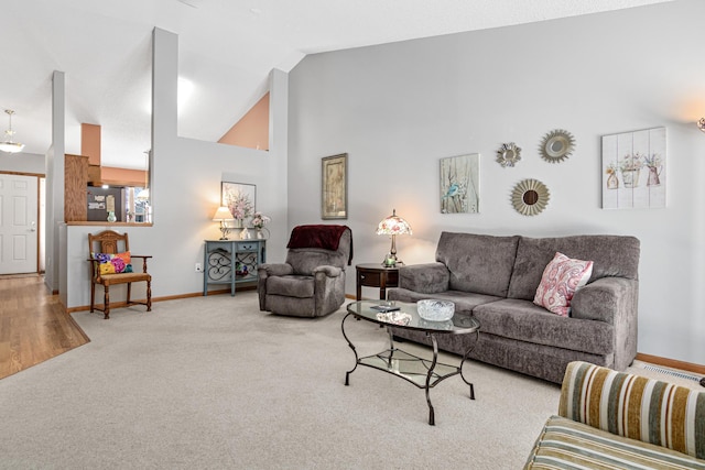 living room with vaulted ceiling and carpet