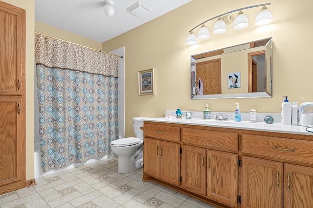 full bathroom featuring toilet, a textured ceiling, shower / bath combination with curtain, and vanity