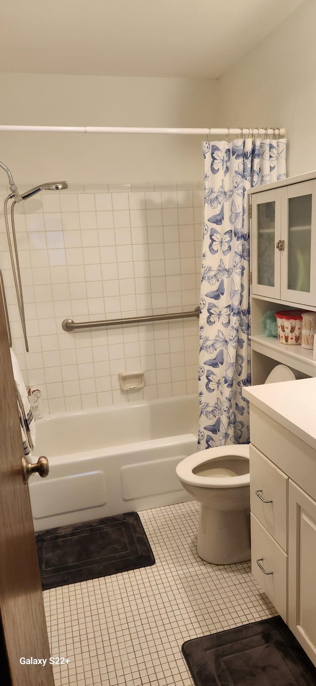 full bathroom with tile patterned flooring, toilet, vanity, and shower / bath combination with curtain