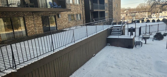 view of snow covered back of property