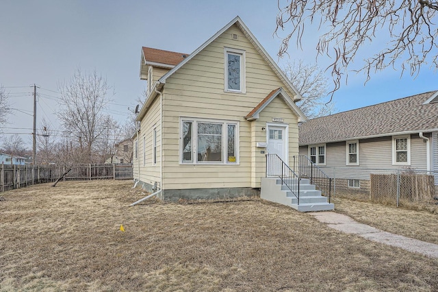 bungalow-style home featuring a front yard