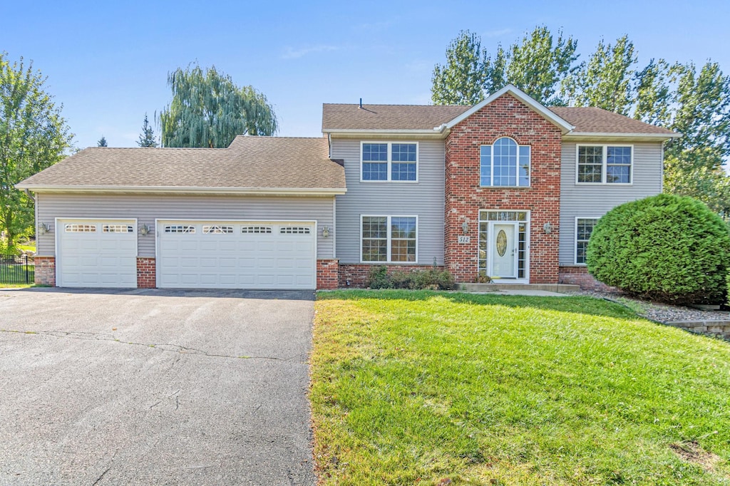 view of front of property with a front yard and a garage