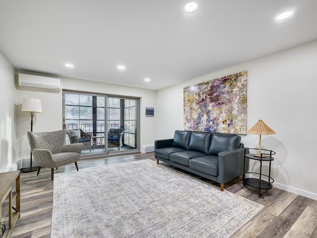 living room with hardwood / wood-style floors and a wall unit AC