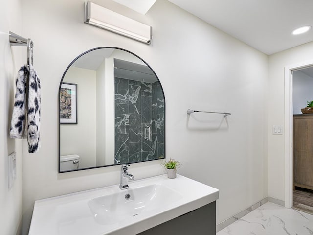 bathroom featuring toilet, an AC wall unit, and vanity