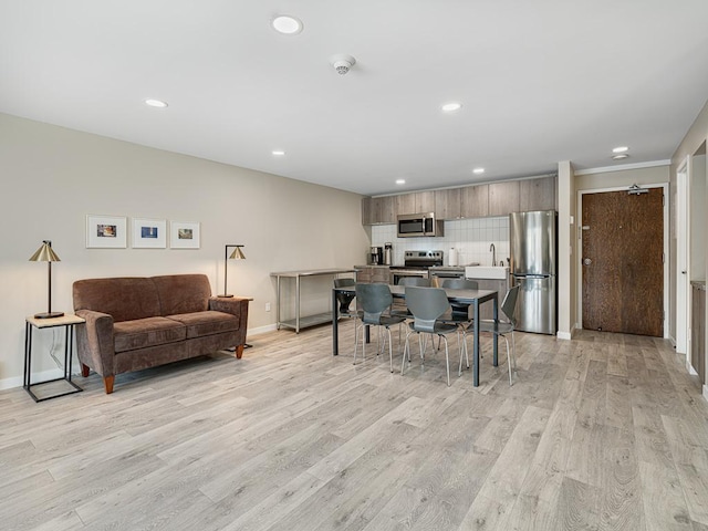 dining room with sink and light hardwood / wood-style floors