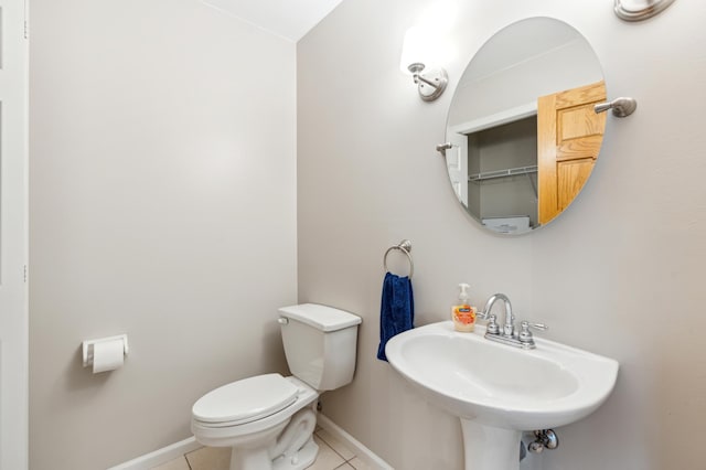 bathroom featuring sink, tile patterned flooring, and toilet