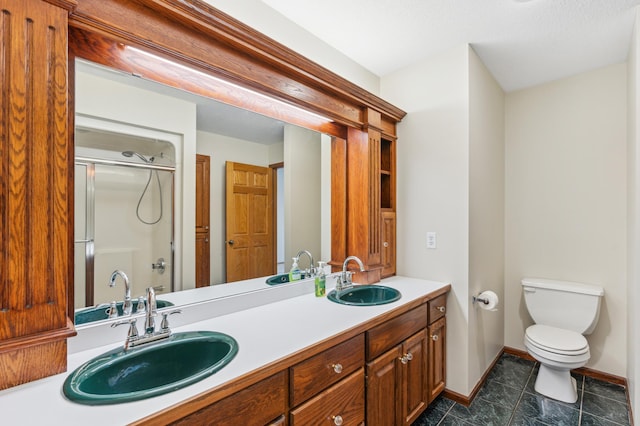 bathroom with vanity, toilet, and an enclosed shower