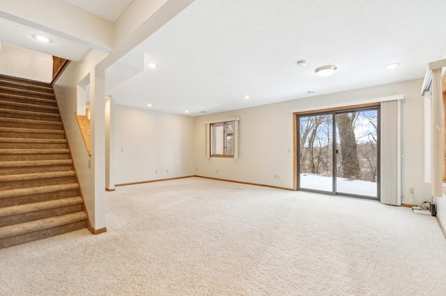 unfurnished living room featuring light colored carpet