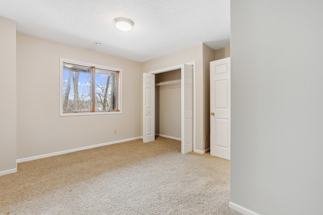 unfurnished bedroom featuring light carpet and a closet