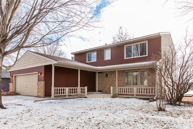 view of front property featuring a garage and a porch