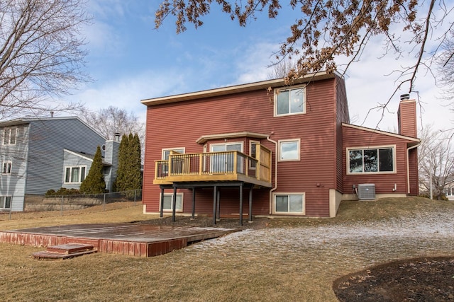 back of property featuring a wooden deck, a yard, and central AC unit