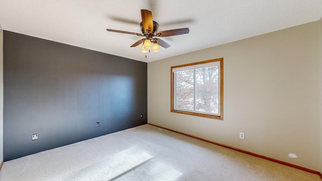 empty room featuring ceiling fan and carpet floors