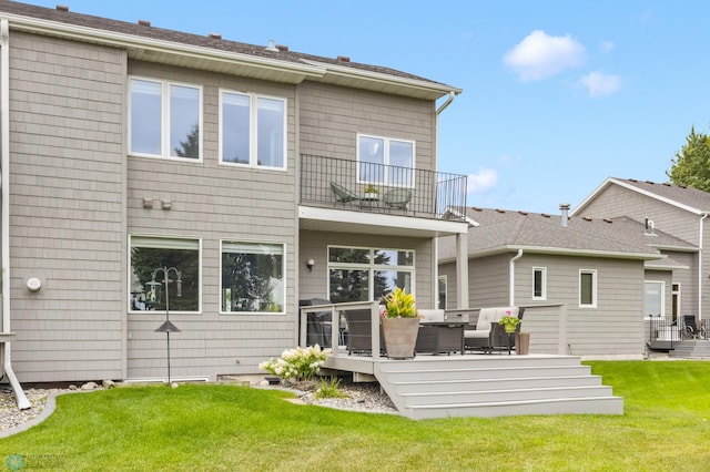 rear view of property with a lawn, a balcony, and an outdoor hangout area