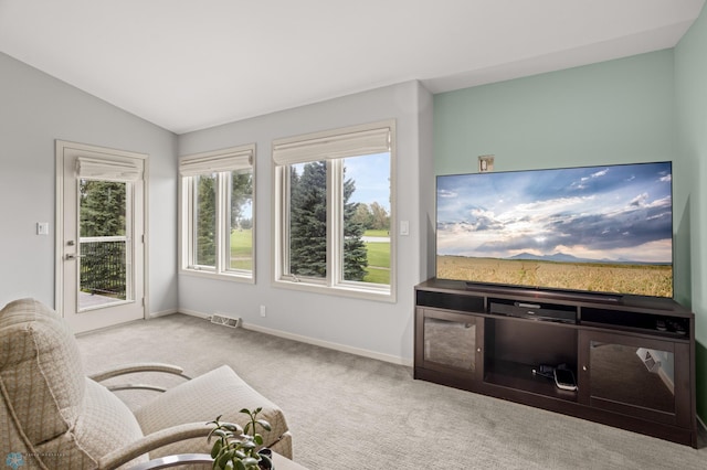 living room with light colored carpet and vaulted ceiling