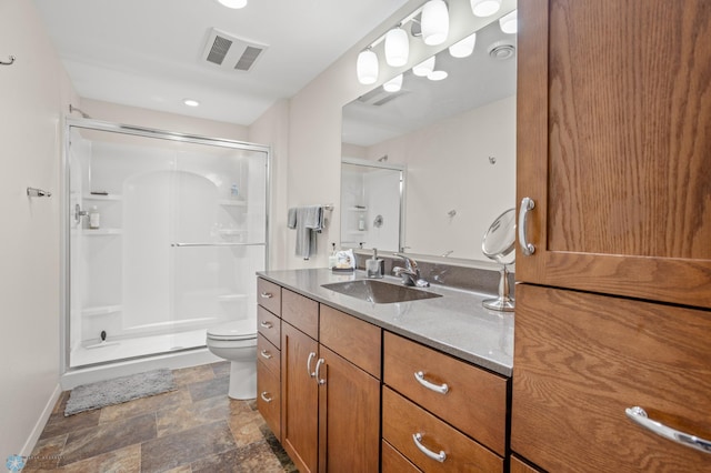 bathroom featuring toilet, walk in shower, and vanity