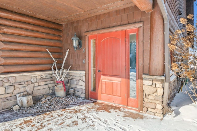 view of snow covered property entrance