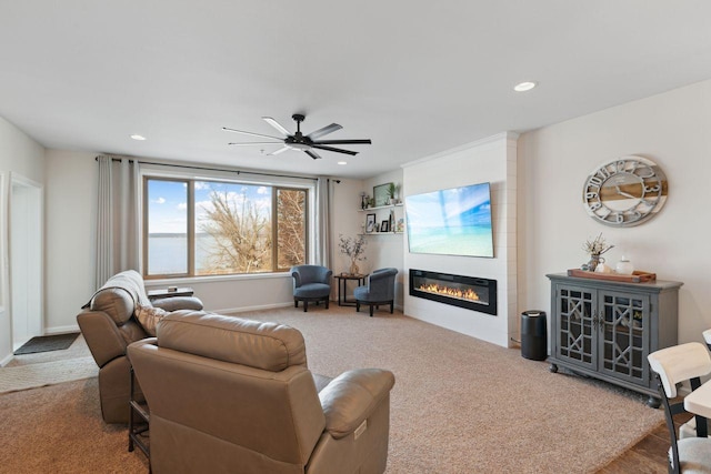 living room featuring a fireplace, carpet, and ceiling fan