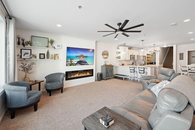 carpeted living room with ceiling fan