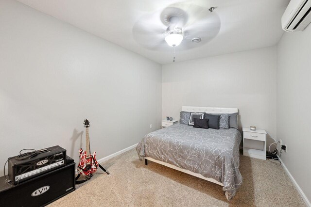 carpeted bedroom with a wall mounted air conditioner and ceiling fan