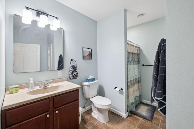 bathroom with vanity, a shower with shower curtain, and toilet