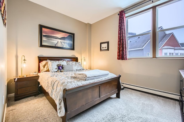 bedroom with carpet and a baseboard radiator