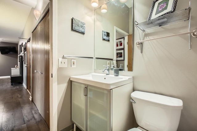 bathroom featuring hardwood / wood-style flooring, vanity, and toilet