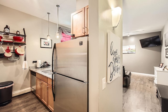 kitchen with a baseboard radiator, hanging light fixtures, appliances with stainless steel finishes, and dark wood-type flooring