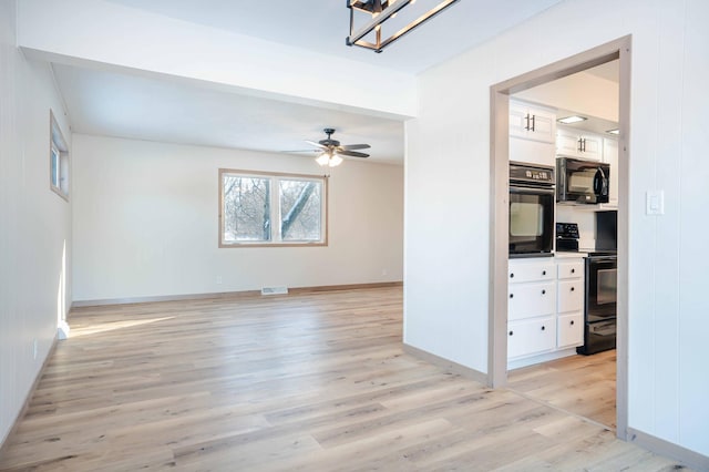 unfurnished room featuring ceiling fan and light wood-type flooring