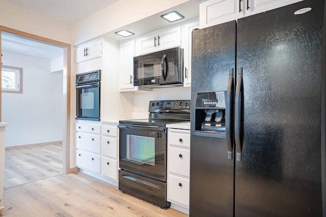 kitchen with black appliances, light hardwood / wood-style flooring, and white cabinets