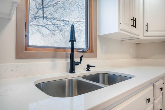 kitchen with sink and white cabinetry