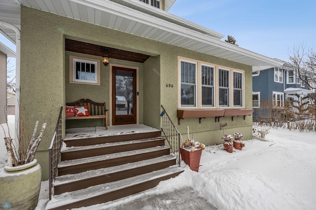 view of snow covered property entrance