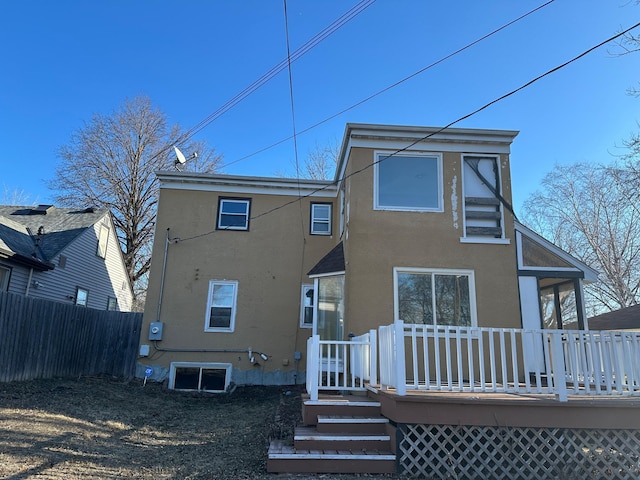 back of house featuring a wooden deck