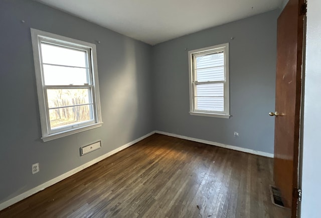 unfurnished room with dark hardwood / wood-style floors